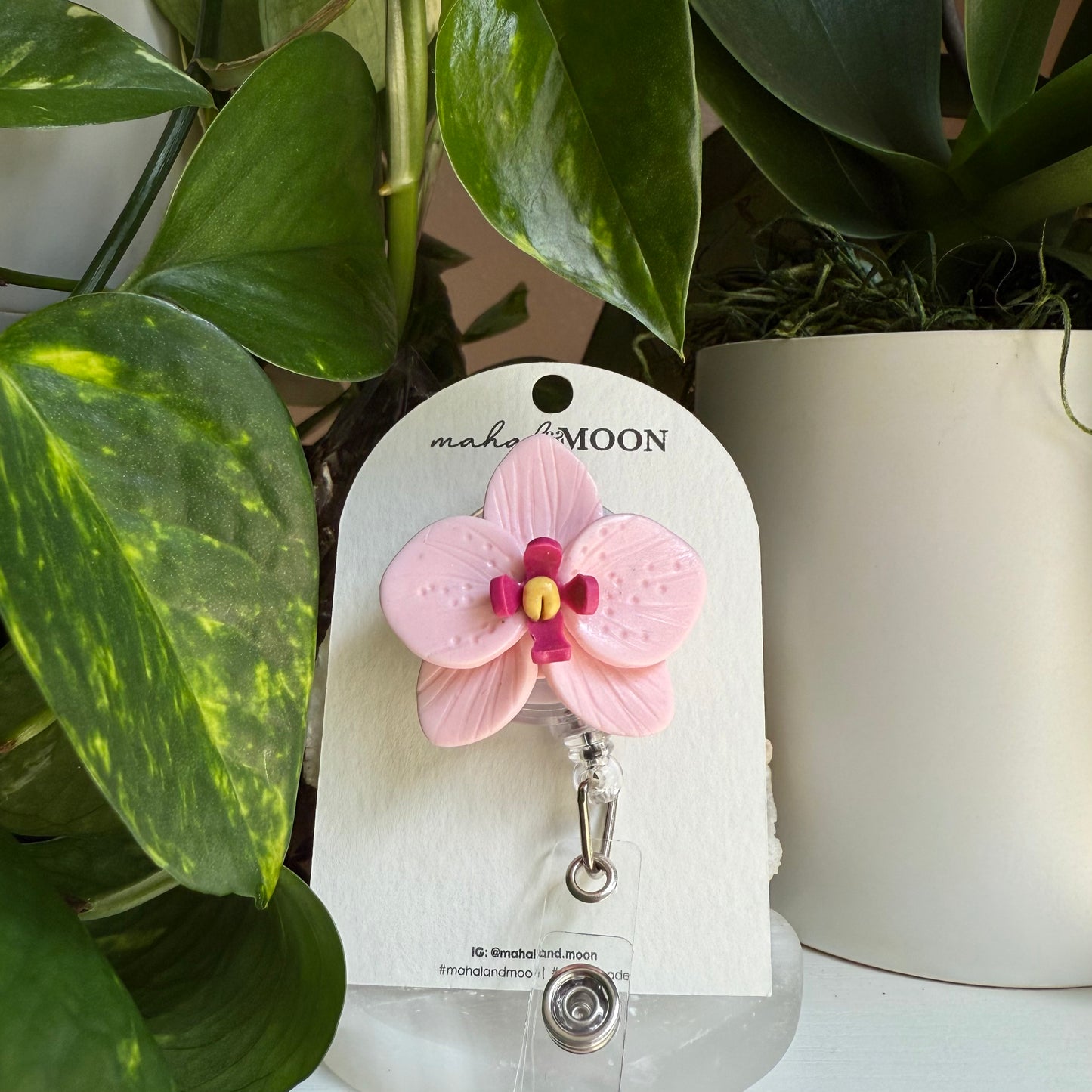 Orchid badge reel